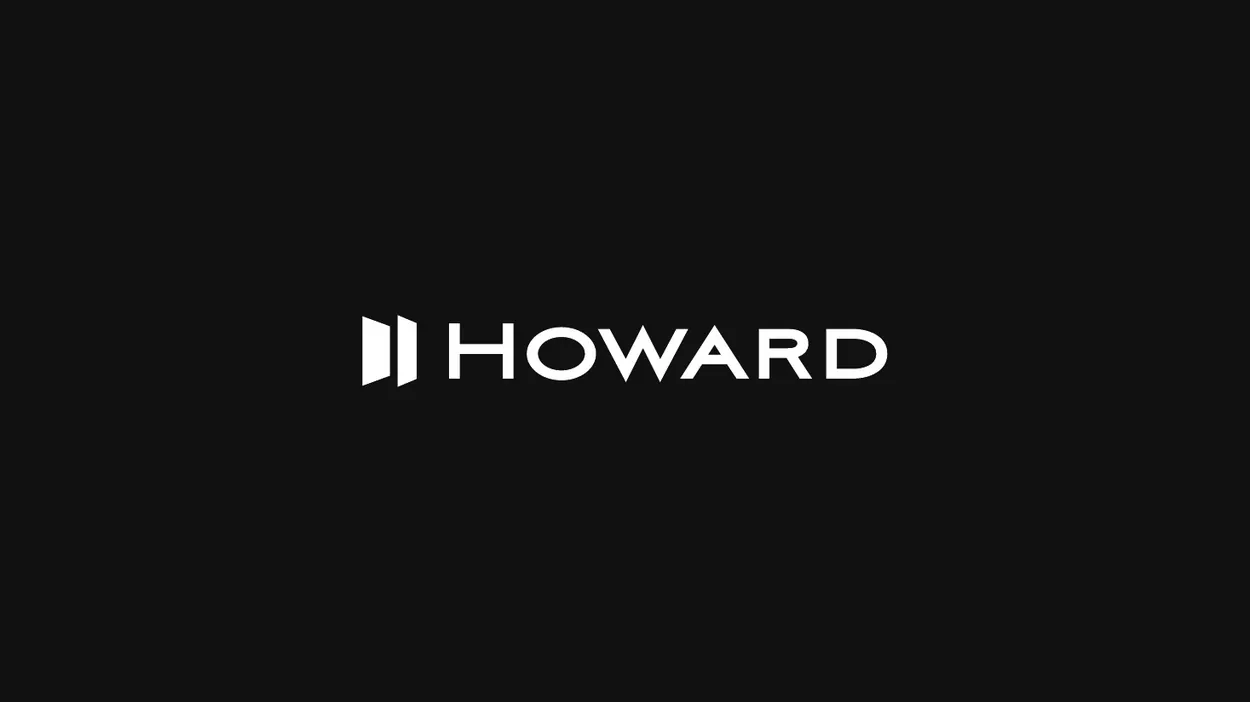 The Howard wordmark and symbol over a city skyline